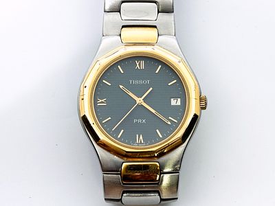 Zegarek męski/unisex Tissot PR100 34 mm. Zegarek stalowy z pozłoceniem, kwarcowy, z DayDate 