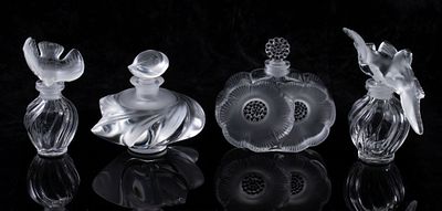 FOUR FRENCH CRYSTAL PERFUME BOTTLES SIGNED LALIQUE. Late 20th Century Bottles in clear crystal 