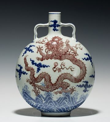 A CHINESE COPPER RED DRAGON ON PORCELAIN MOONFLASK. The flattened body with short neck and 