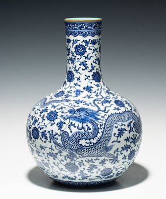 A CHINESE BLUE AND WHITE DRAGON AND LOTUS BOTTLE VASE. The globular body below a tall 