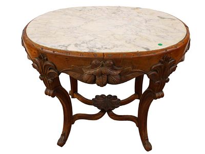 Antique highly carved oval marble top Victorian parlor table in the oak and walnut woods with
