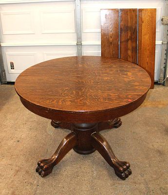 Antique 44" diameter quartersawn oak table with paw feet and (3) 9 1/2" leaves approx. 30" h