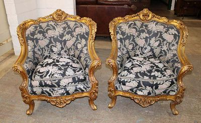 Pair of highly carved French style parlor chairs in the gold frame approx. 36" w x 38" d x 40" h
