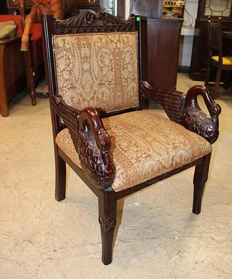 Solid mahogany winged swan carved arm chair. Solid mahogany winged swan carved decorator arm 