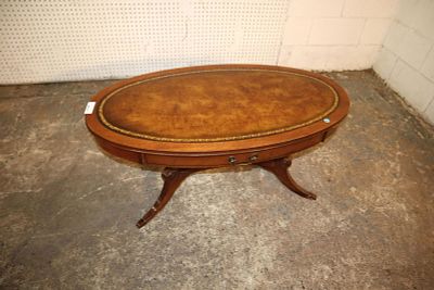 Vintage mahogany oval leather top coffee table. Vintage mahogany oval leather top faux drawer