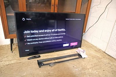 Working LG 50" Smart TV with remote, wall mounts and bracket, and stand legs
