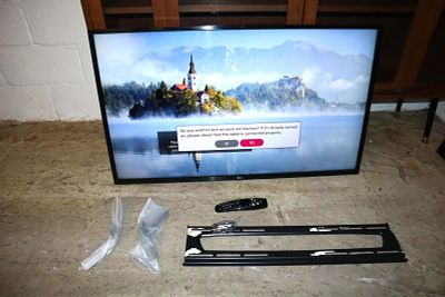 Working LG 42" Smart TV with remote, wall mounts and bracket, and stand legs