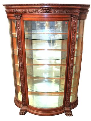 Antique carved curve glass oak paw foot china cabinet. Antique highly carved and curve glass oak 