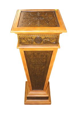 Decorator pedestal in a light mahogany finish, embossed carved top and sides, structurally