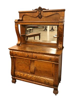 Antique oak mirrored back buffet with mirror top. Antique oak mirrored back buffet with carved 