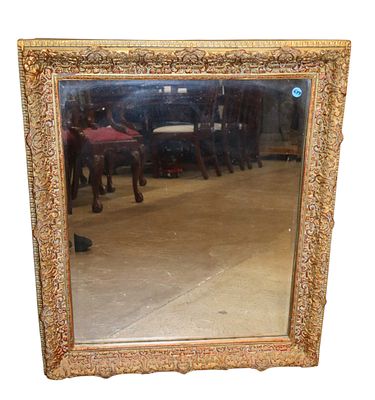 Antique beveled mirror in carved wood and gesso frame. 32"h x 27"w x 2"d