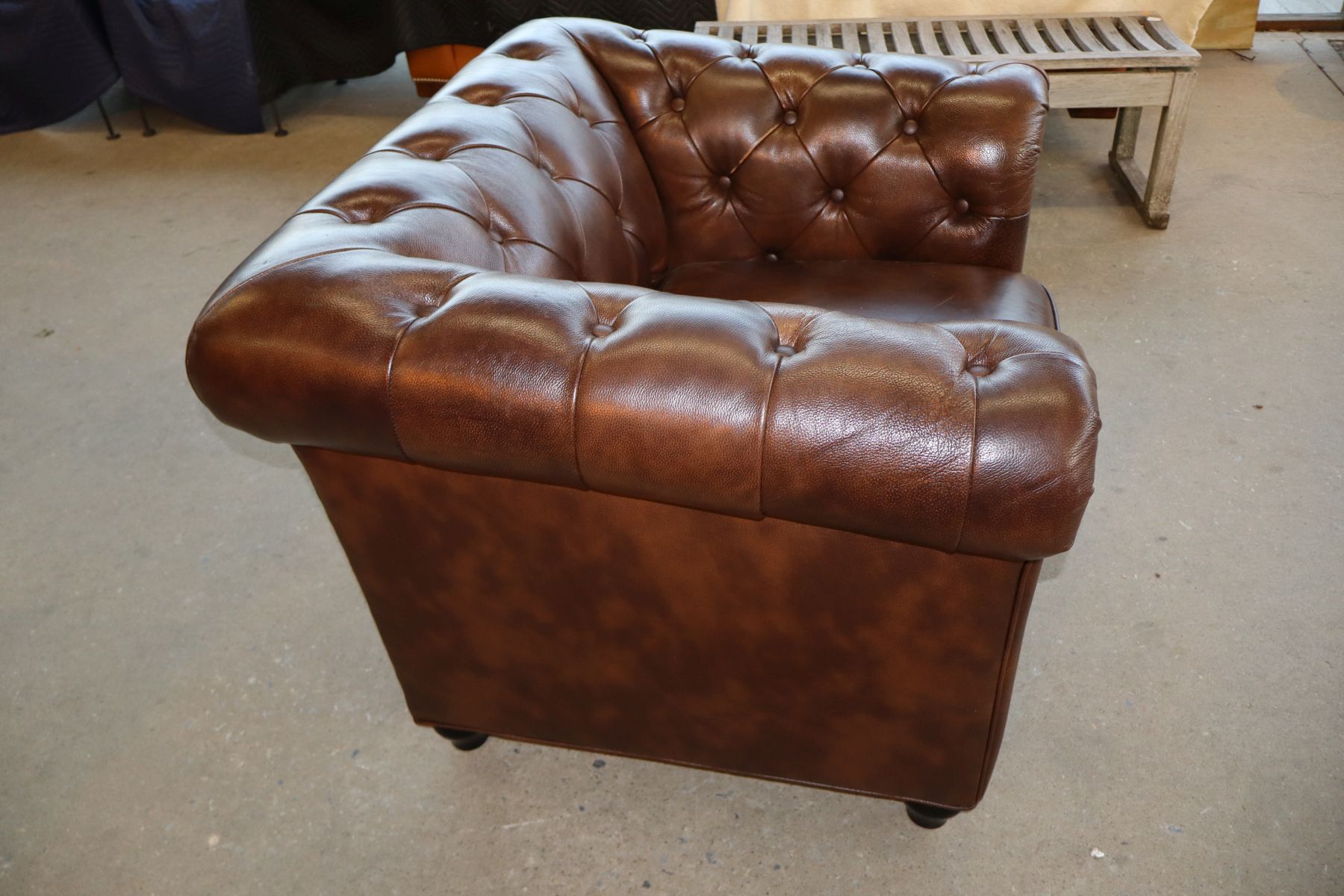Brown leather even arm button tuft club chair