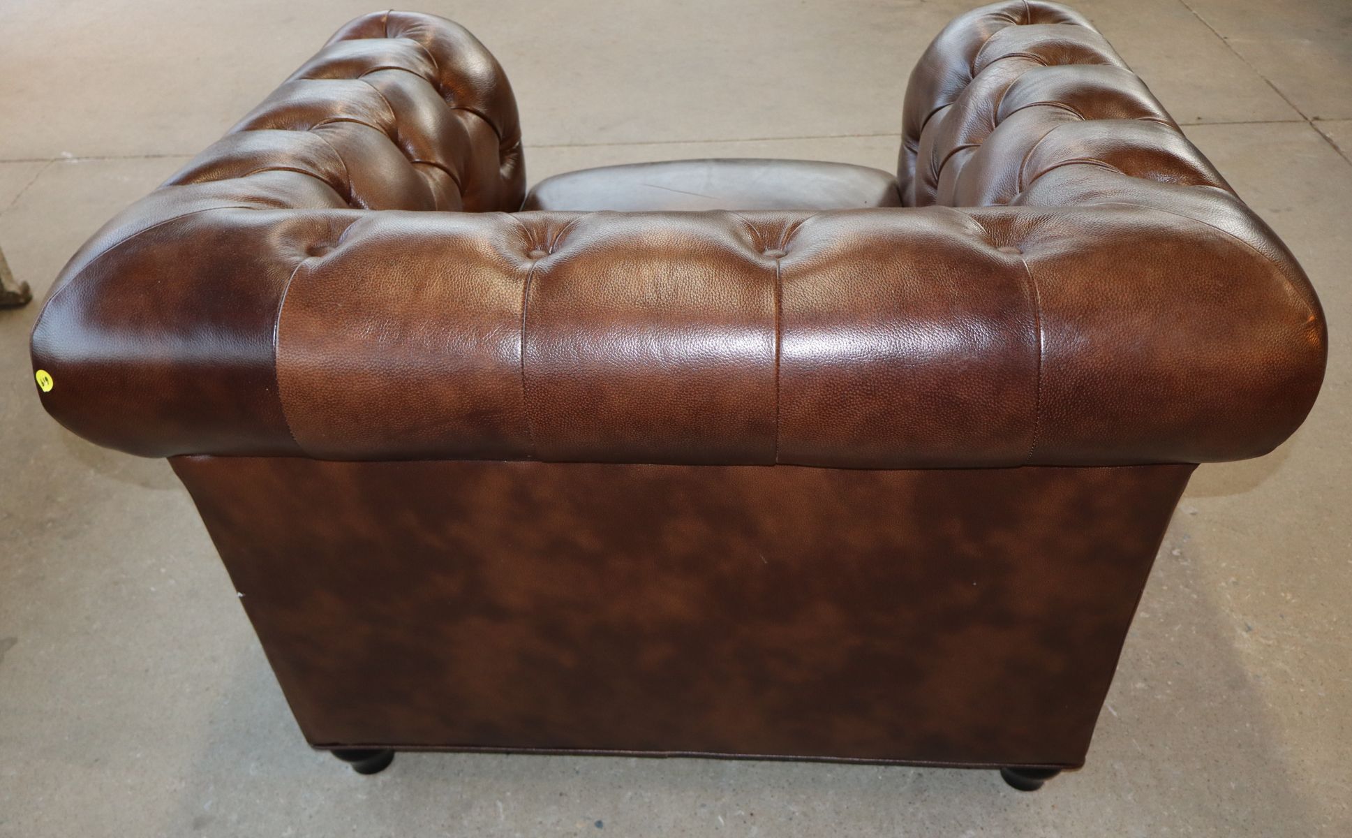 Brown leather even arm button tuft club chair