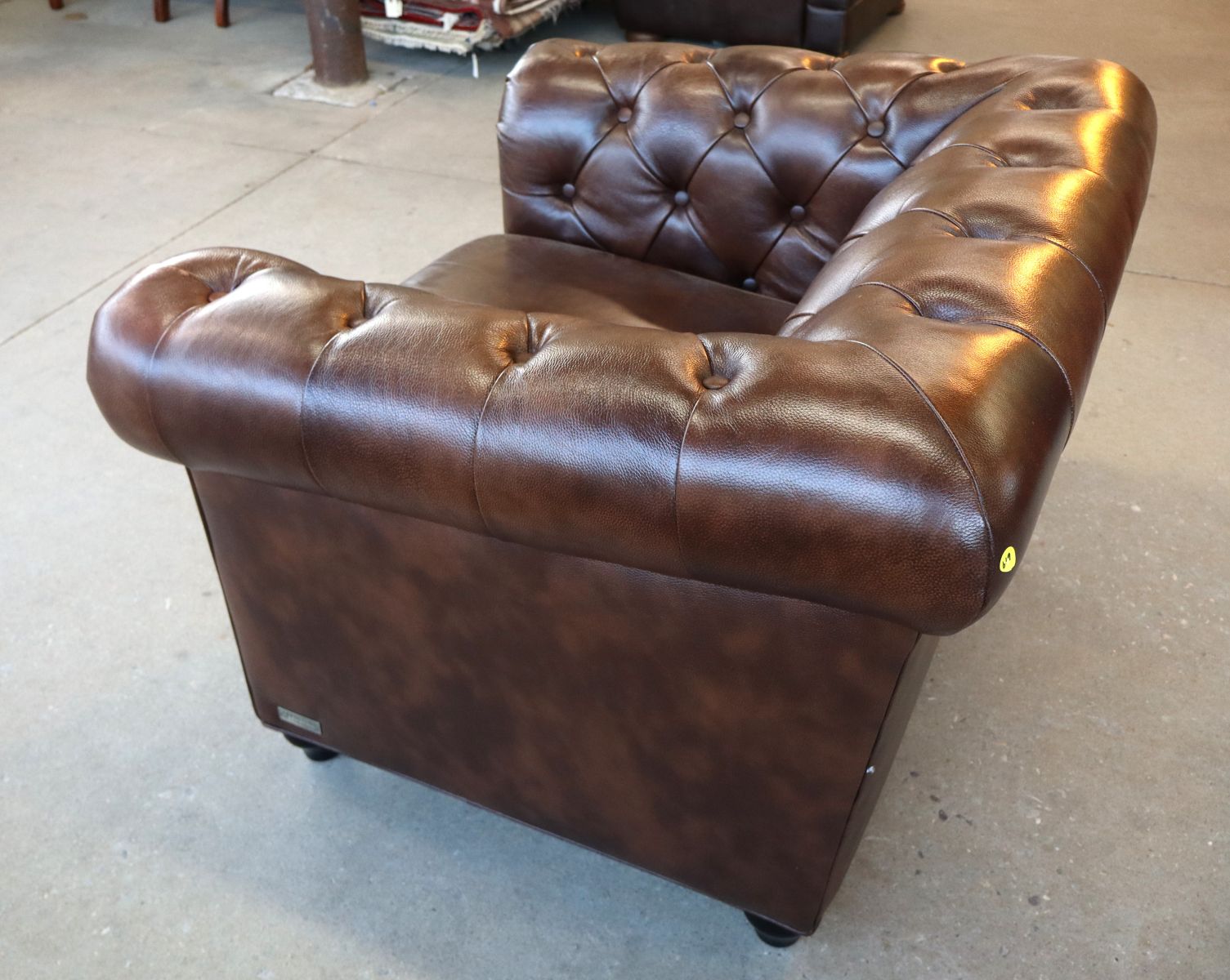 Brown leather even arm button tuft club chair