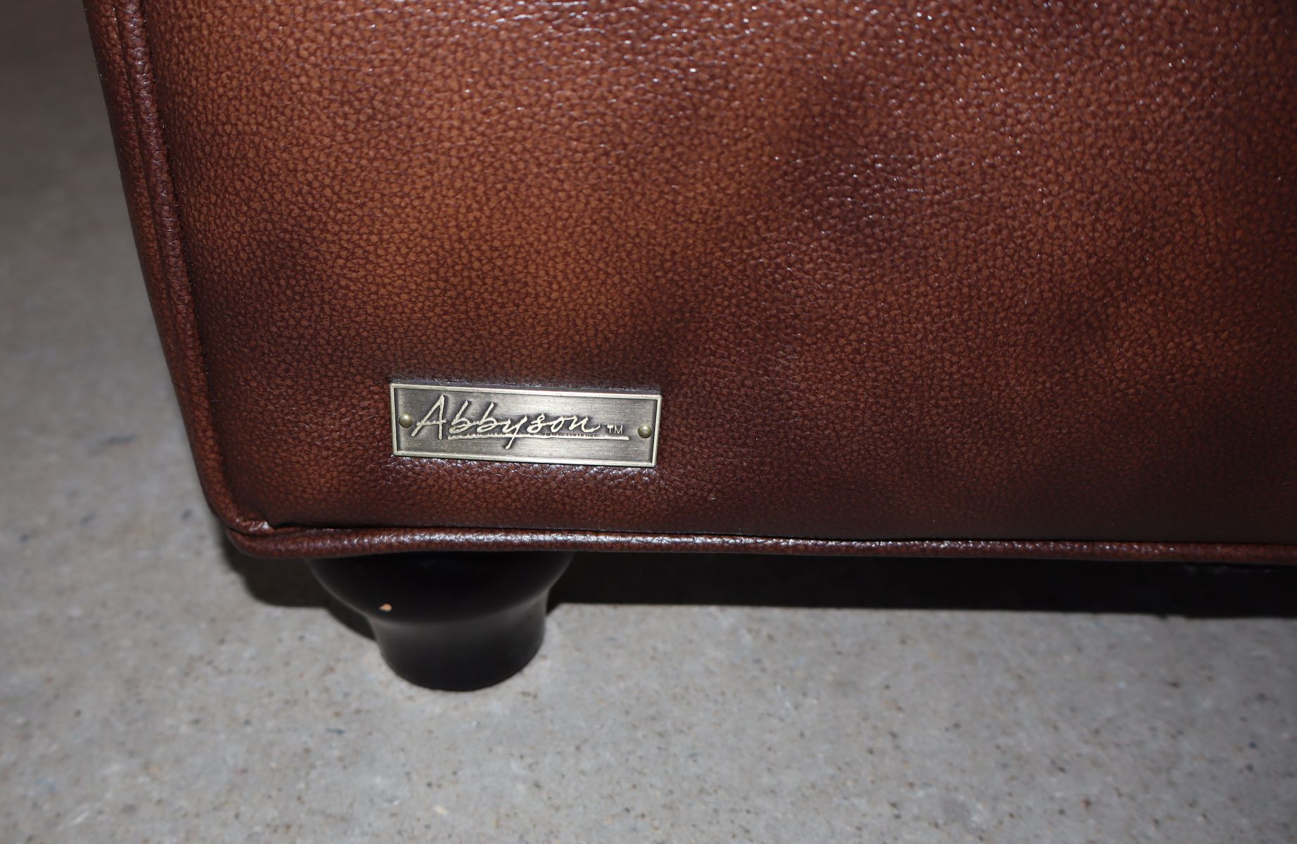 Brown leather even arm button tuft club chair