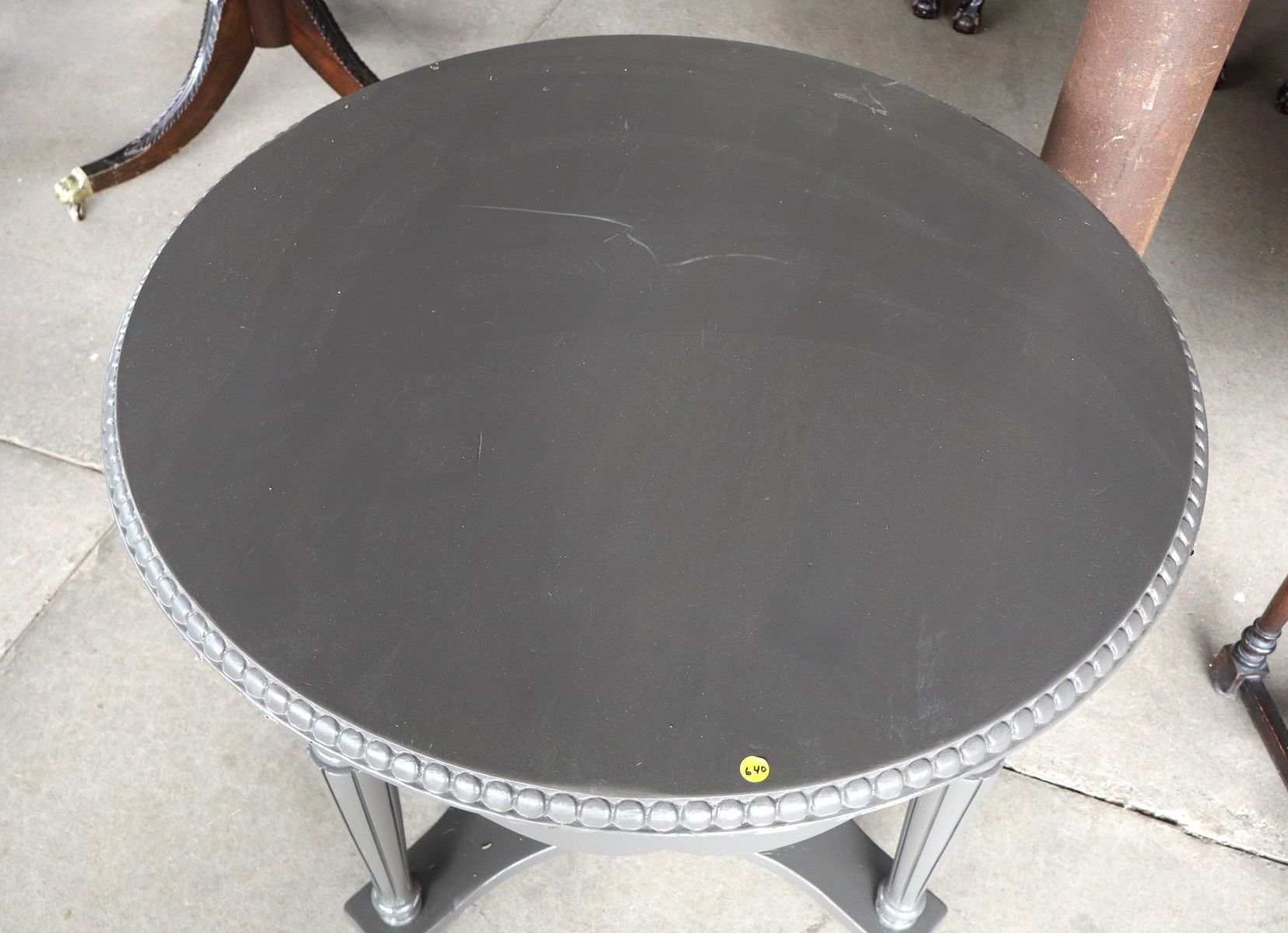 Carved 38" round center table in grey paint