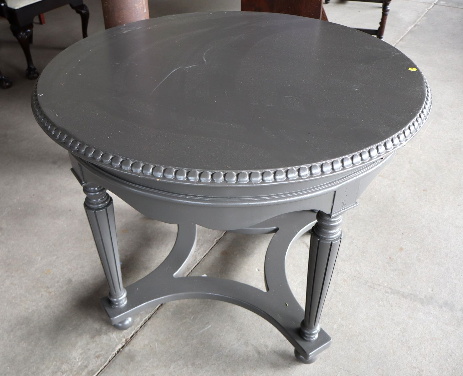 Carved 38" round center table in grey paint