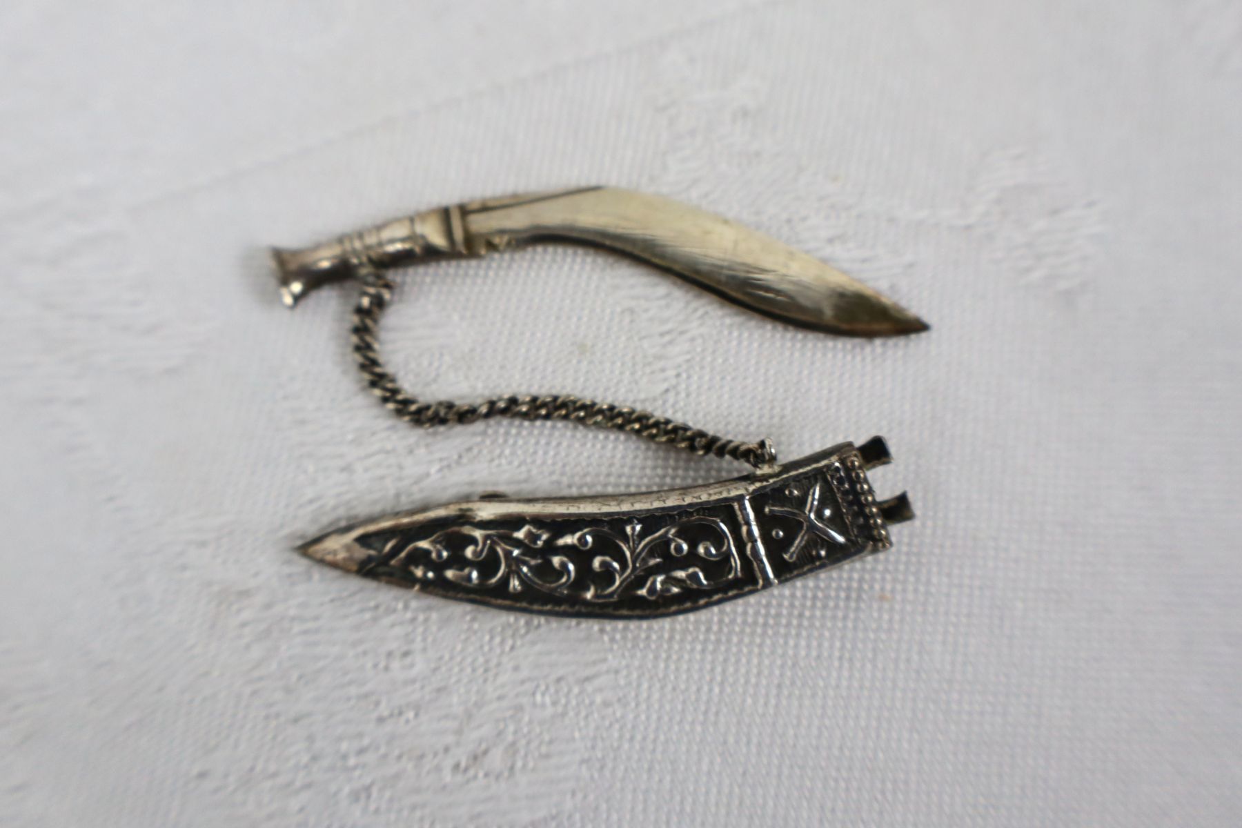 Asian silver knife brooch with sleeve