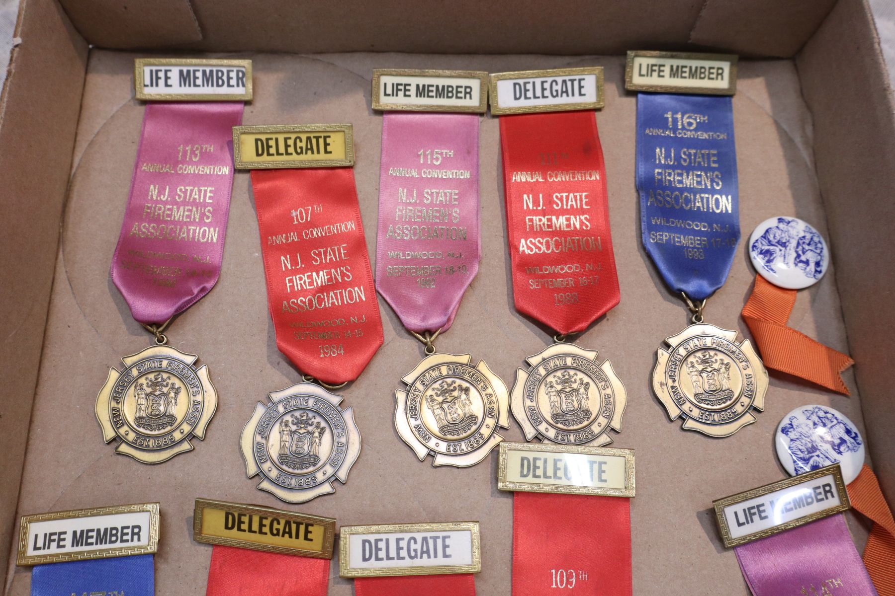 Several vintage fireman badges, buttons and other