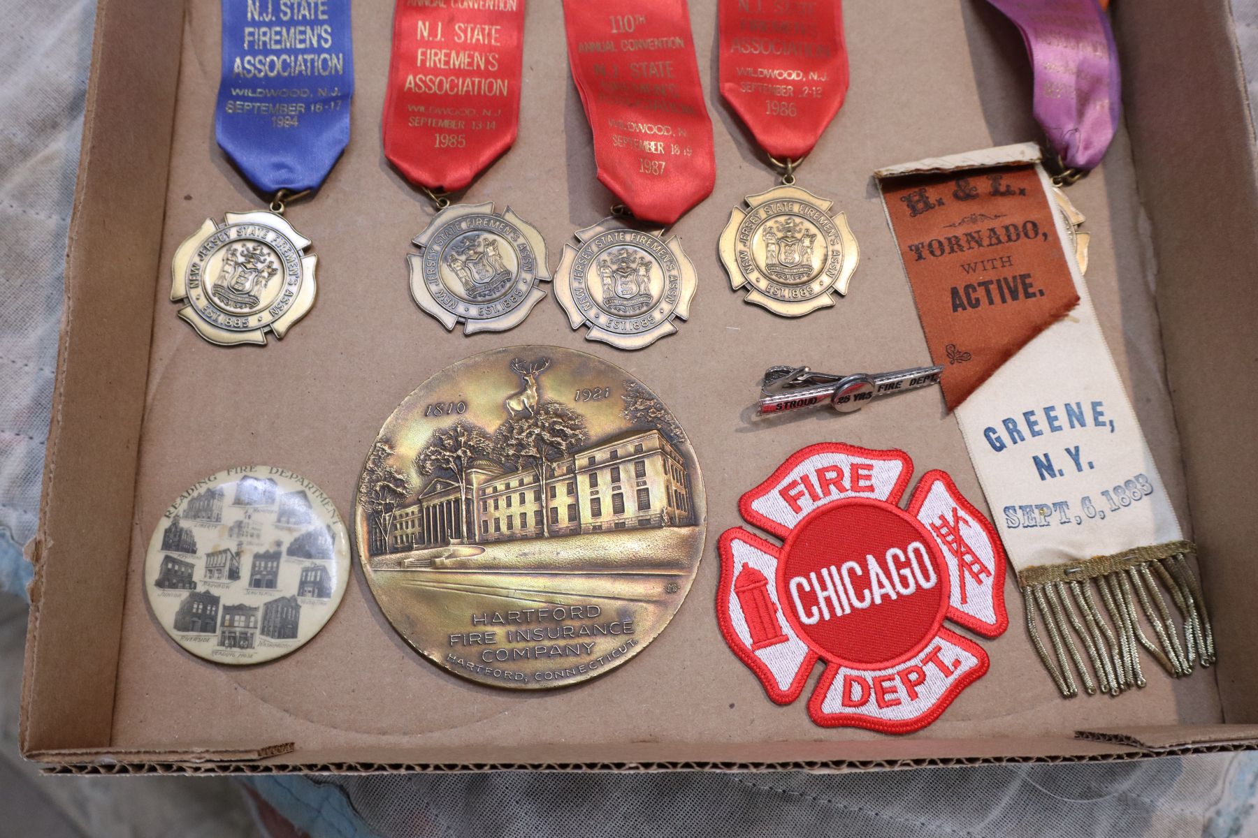 Several vintage fireman badges, buttons and other
