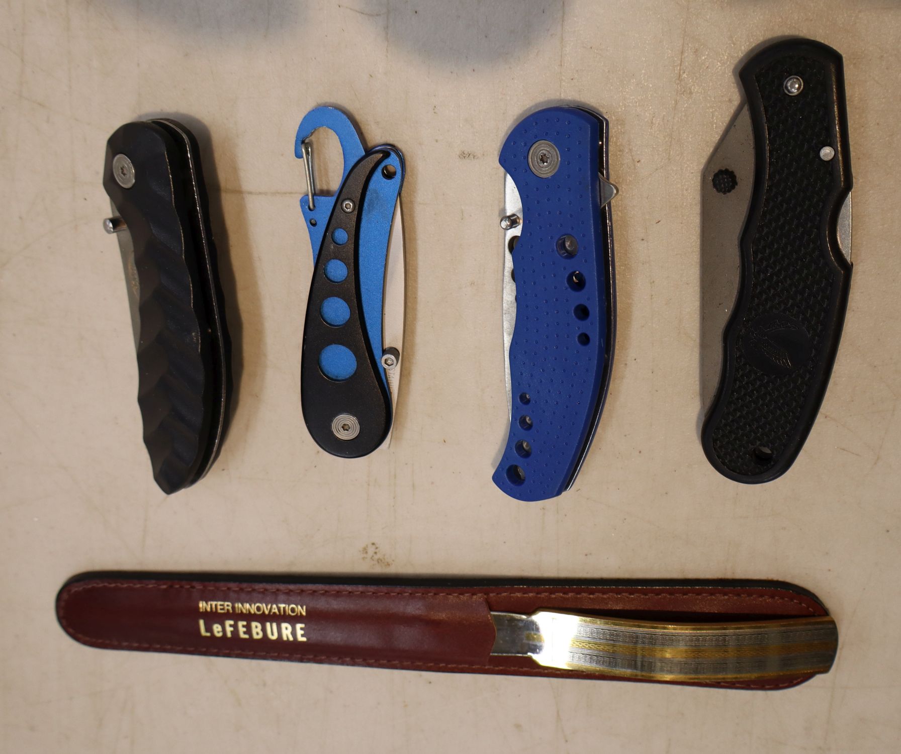 4 folding pocket knives and a LeFebure letter opener