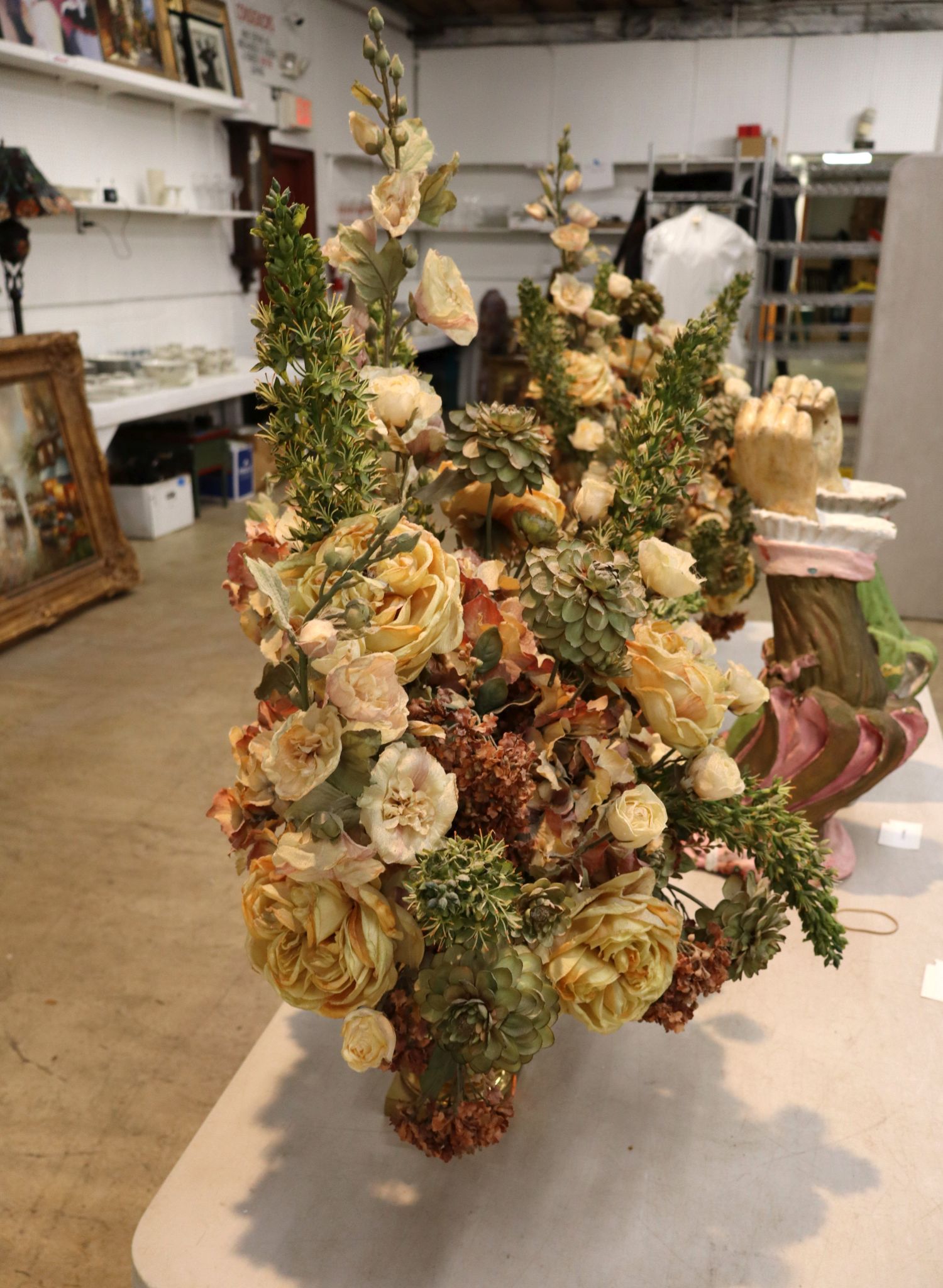 Quality faux floral arrangement in brass double handle vase