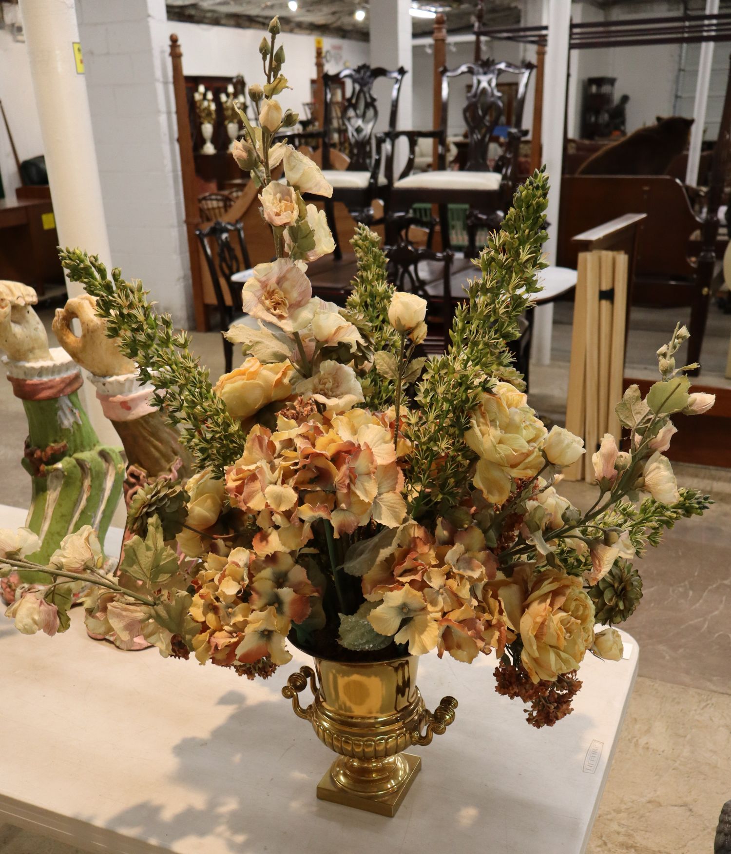 Quality faux floral arrangement in brass double handle vase