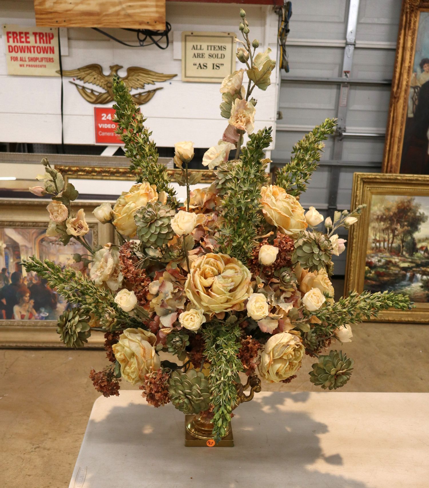 Quality faux floral arrangement in brass double handle vase
