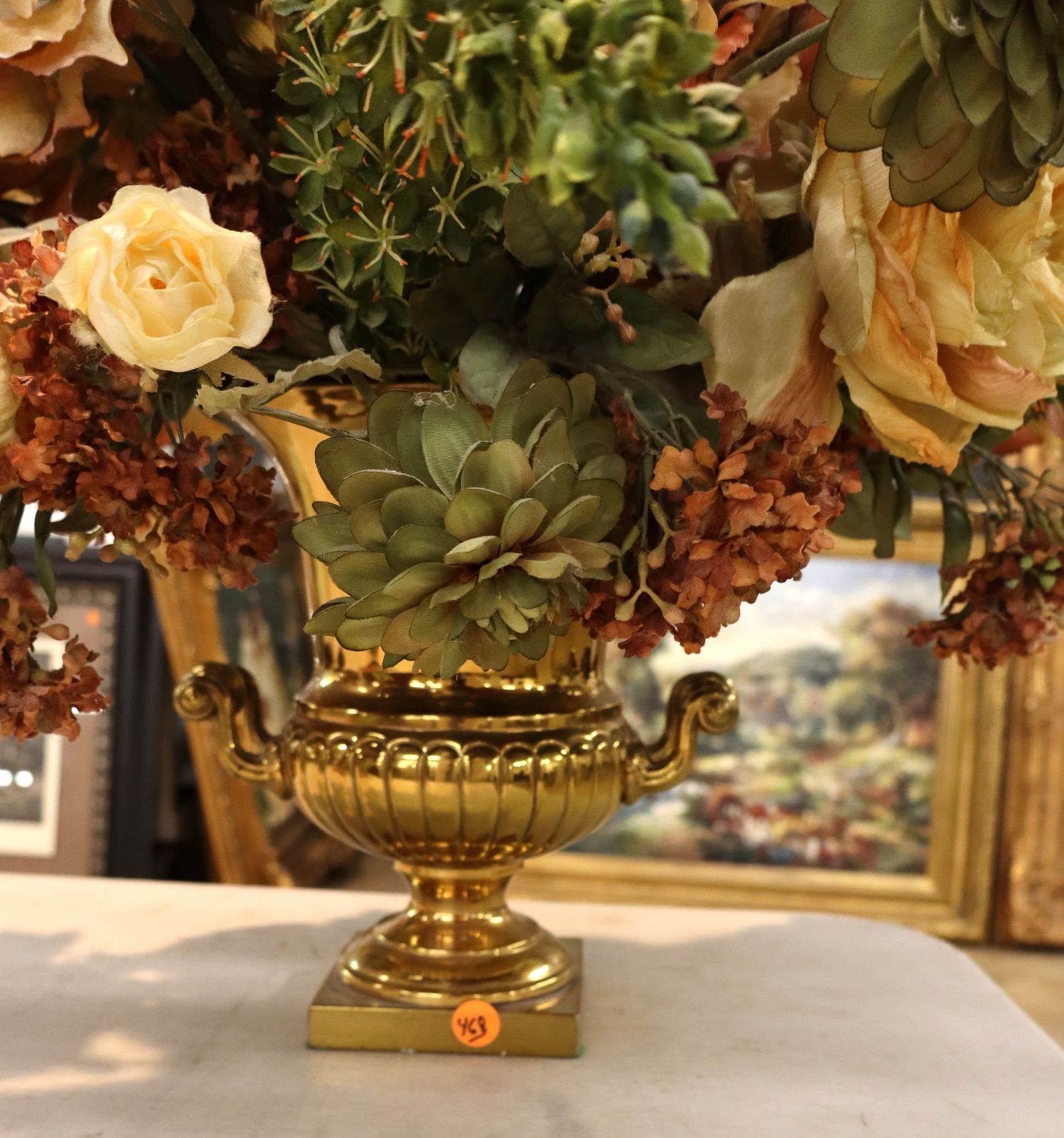 Quality faux floral arrangement in brass double handle vase