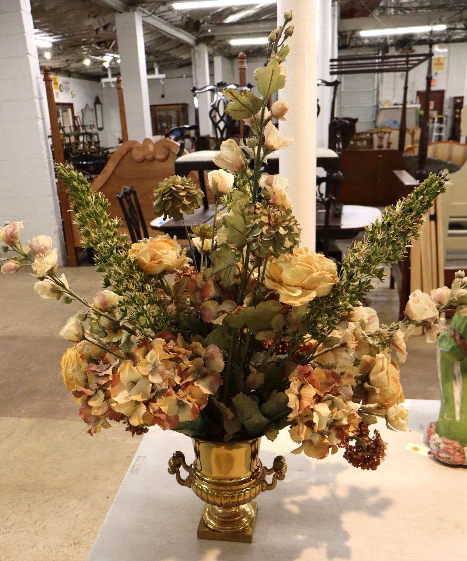 Quality faux floral arrangement in brass double handle vase