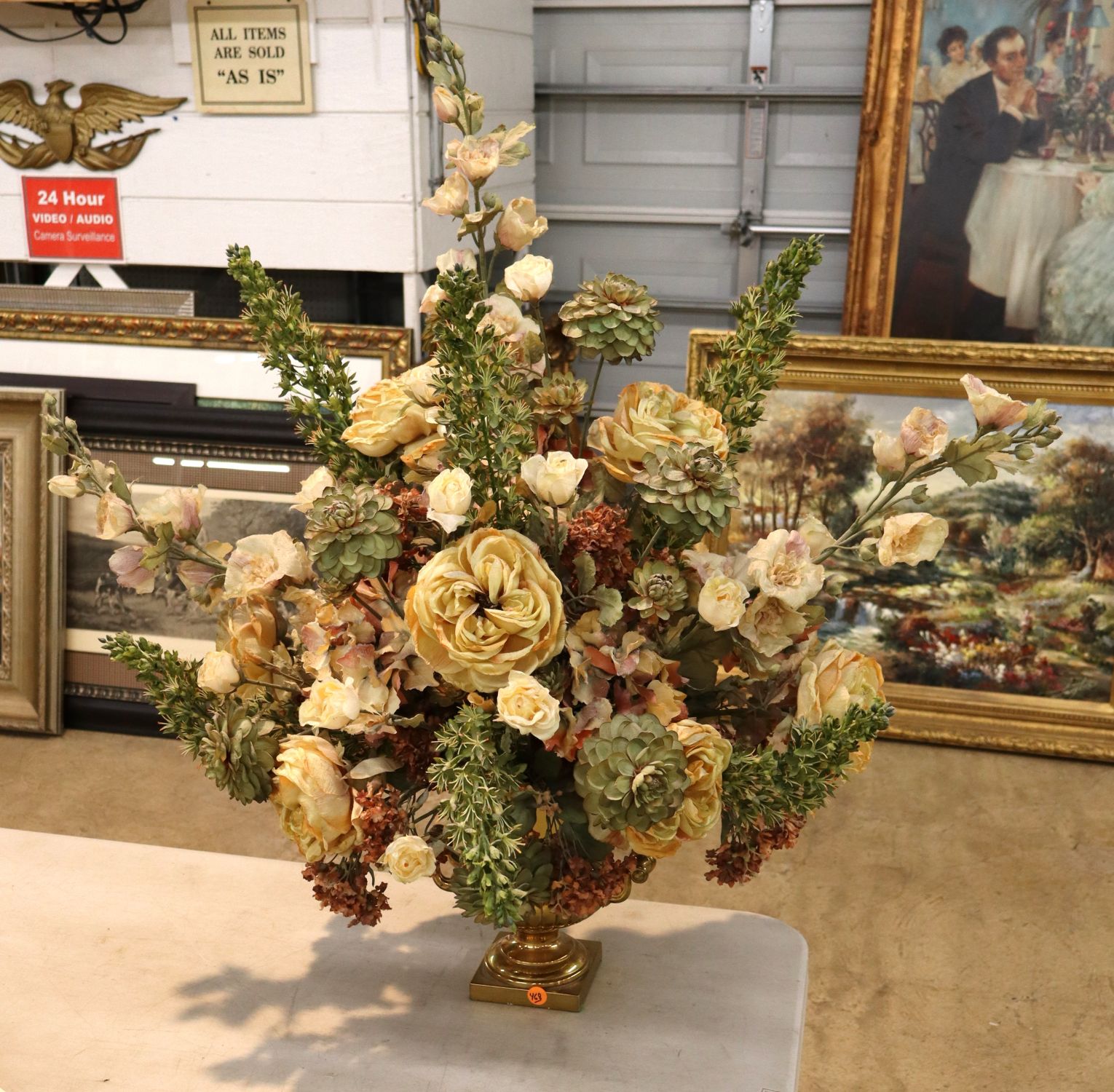 Quality faux floral arrangement in brass double handle vase