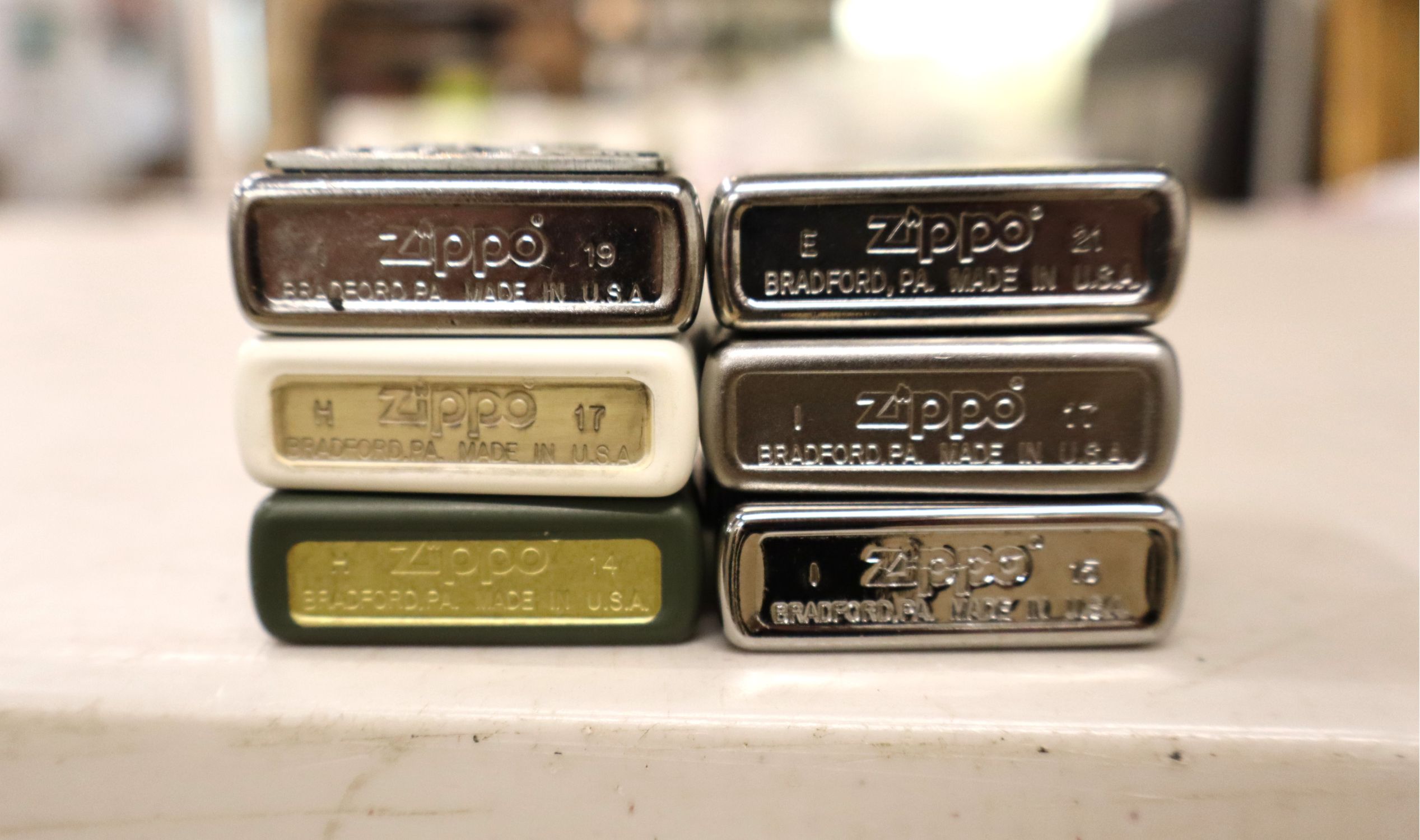 6 vintage Zippo lighters.