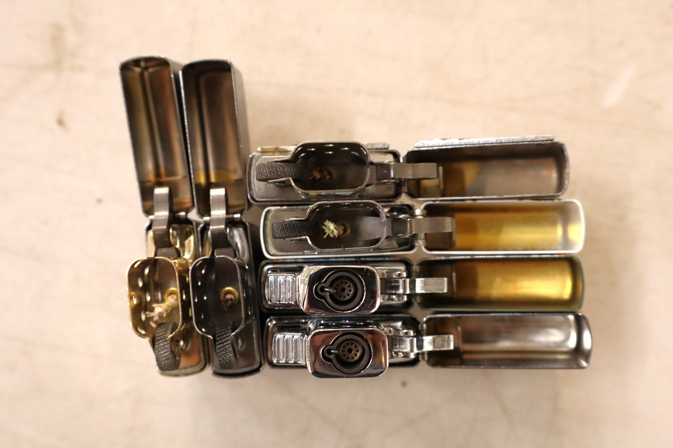 6 vintage Zippo lighters.