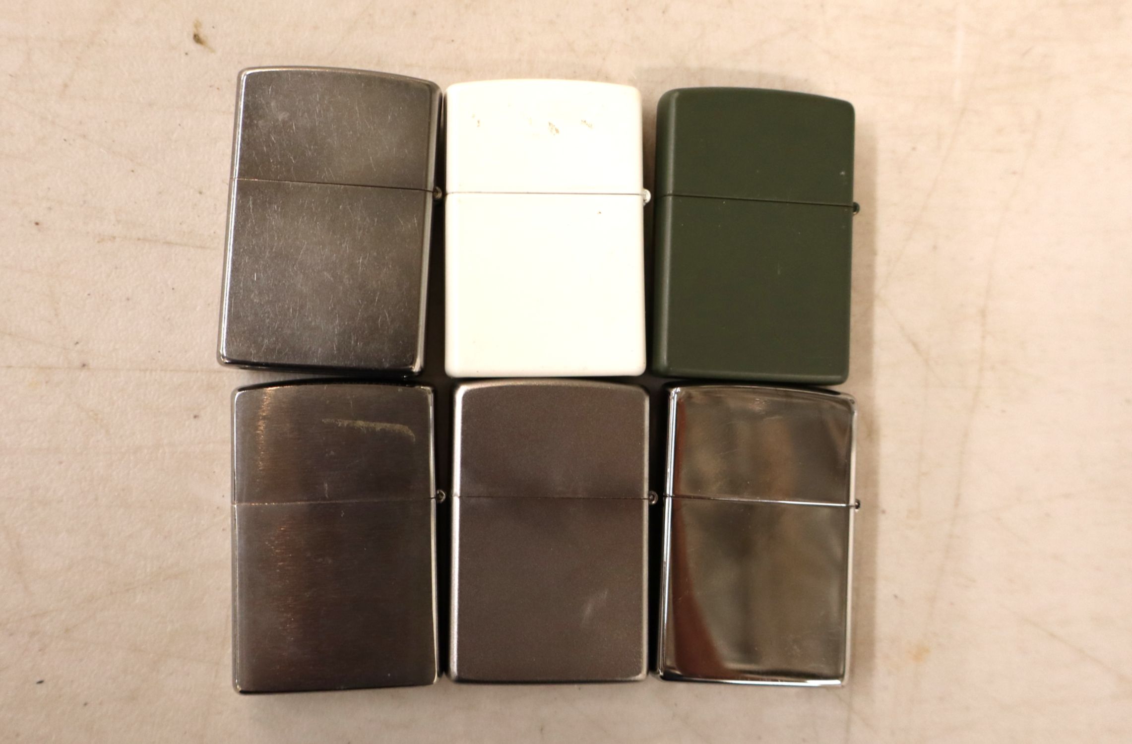6 vintage Zippo lighters.