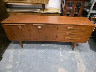 A Beautility Mid-Century Modern Teak Sideboard. A single Mid-Century Modern sideboard or 