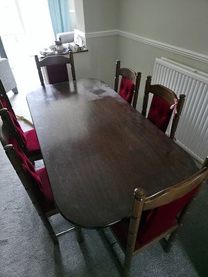 A Seven-Piece Jacobean Revival Style Dining Suite. A seven-piece dining suite comprising one 