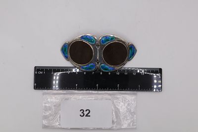 A Unique Enamelled Silver Belt Buckle Featuring Victoria Bun Head Centre Design on Each Side 