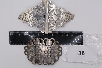 A Pair of Solid Silver Nurses Belt Buckles Featuring Fretwork and Floral Scroll Designs - 