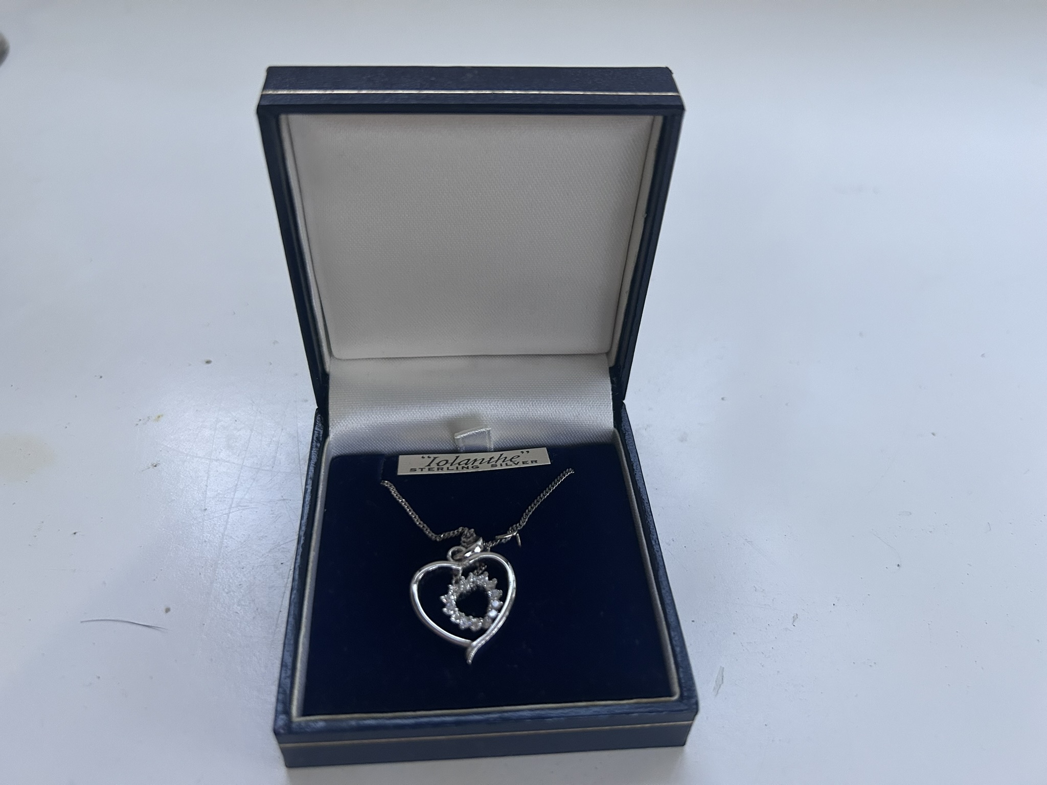 Necklace featuring a central love-heart set with crystals and crafted in solid silver