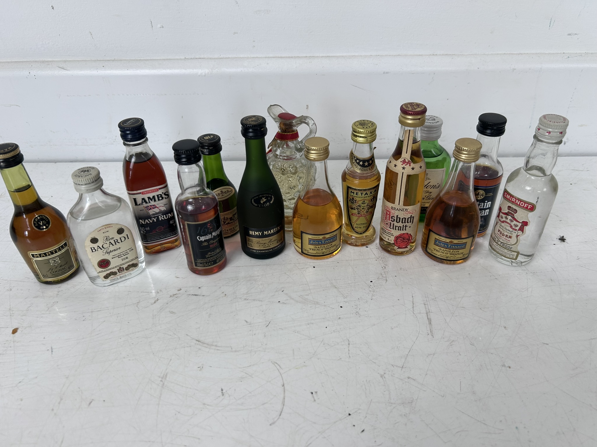 Small collection of over a dozen miniatures comprising Cognac, Rum, Vodka, Gin and others, 14 bottles in total