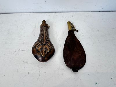 Antique 19th-century powder flask features an embossed foliate / shell design on a brass body 