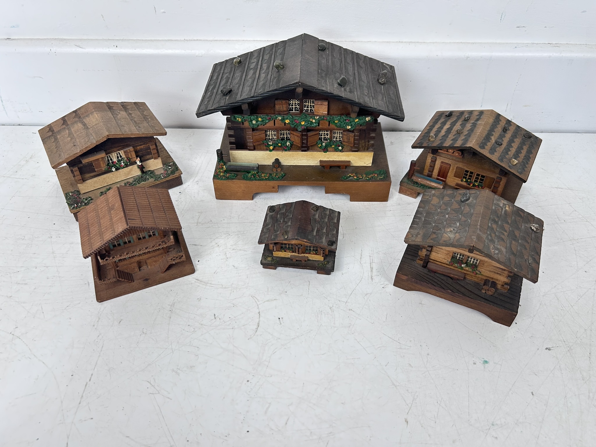 Collection of mostly Swiss Lador music boxes in the form of Swiss houses