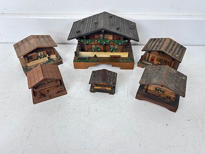 Collection of mostly Swiss Lador music boxes in the form of Swiss houses