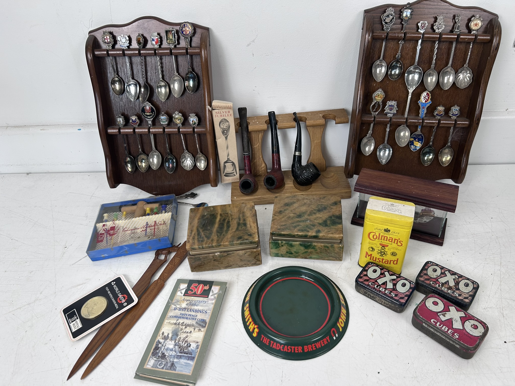 A mixed collectable lot of vintage pipes and pipe rack, vintage tins including Coleman mustard and Oxo as well as silver plated spoons and commemorative coin
