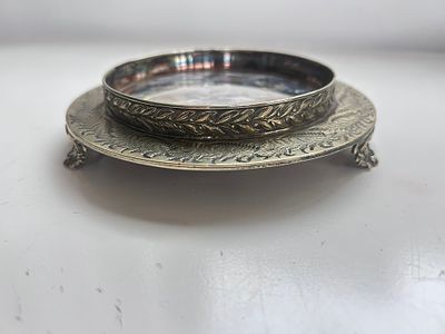 A white metal footed wine coaster stand or bottle stand salver with markings to the underside