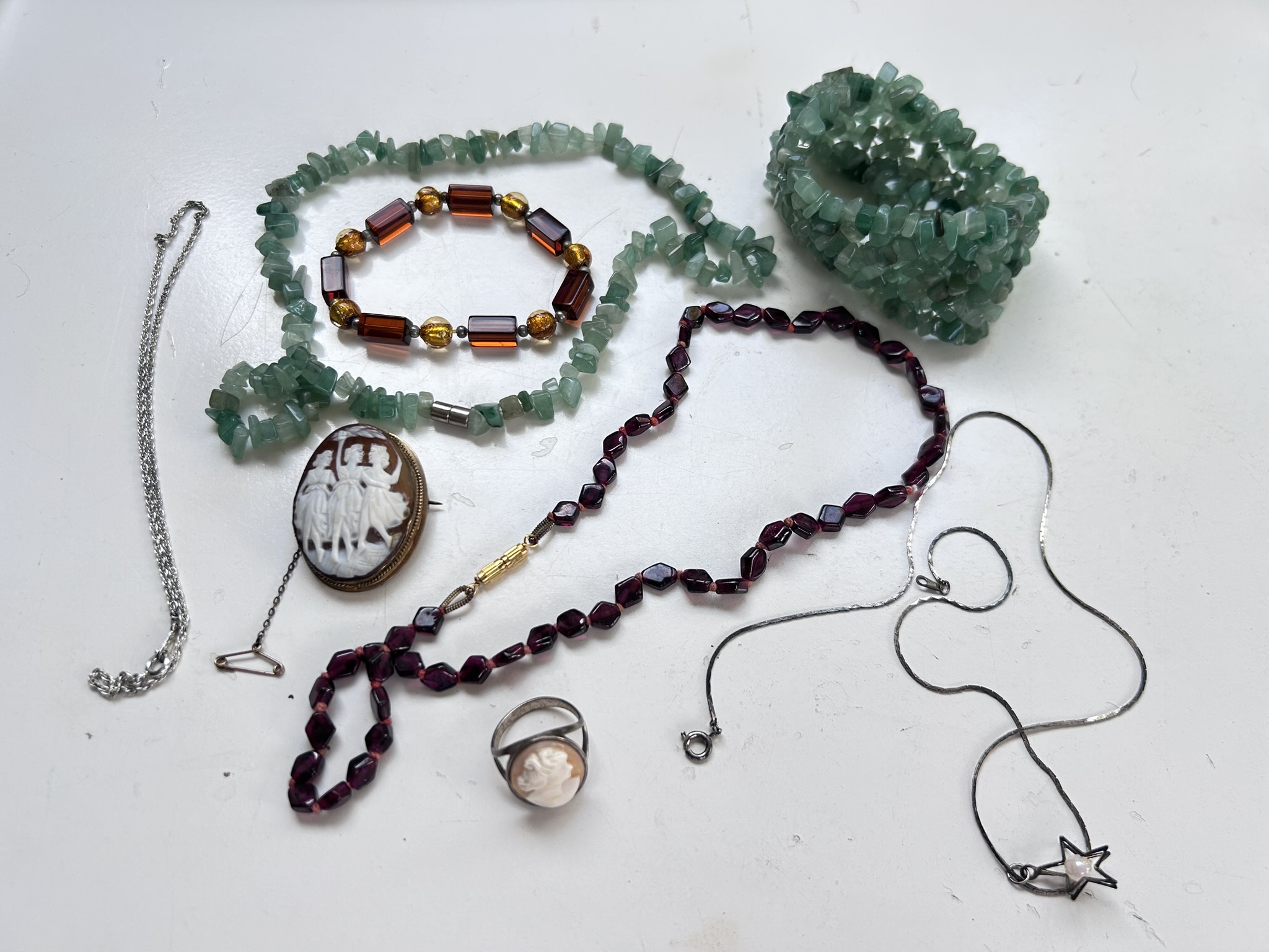 A small collection of vintage and antique costume jewellery comprising Aventurine bracelet and necklace, cameo brooch and cameo ring, silver tone necklaces etc
