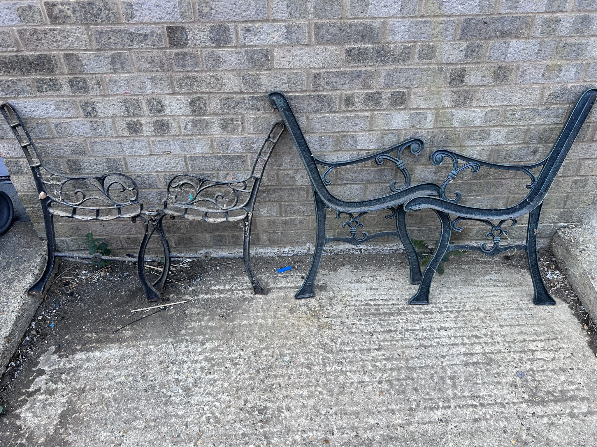 Two pairs of heavy cast iron bench ends