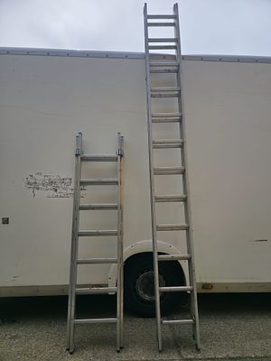 Pair of Very Large Aluminium Extension Ladders. Two aluminium extension ladders of varying 