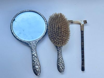 An antique silver mirror (a/f) and hairbrush set, UK hallmarks and a 18ct gold plated stick 