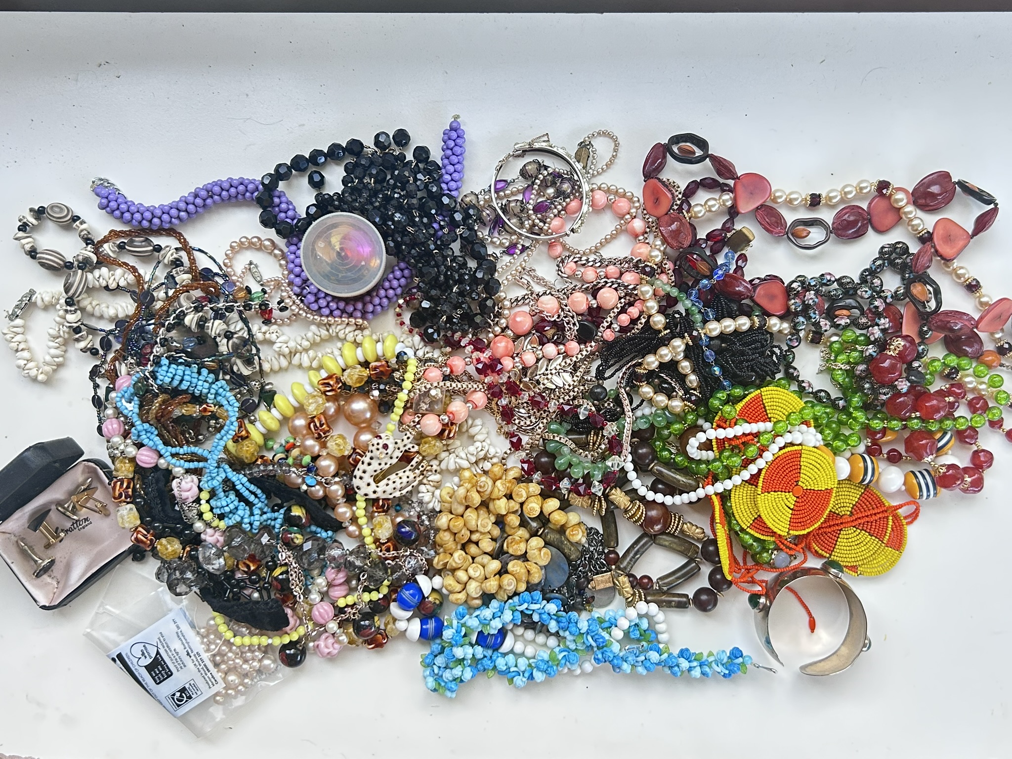 A large quantity of largely vintage costume jewellery, mainly comprising necklaces but with some bangles, bracelets, cuff links etc